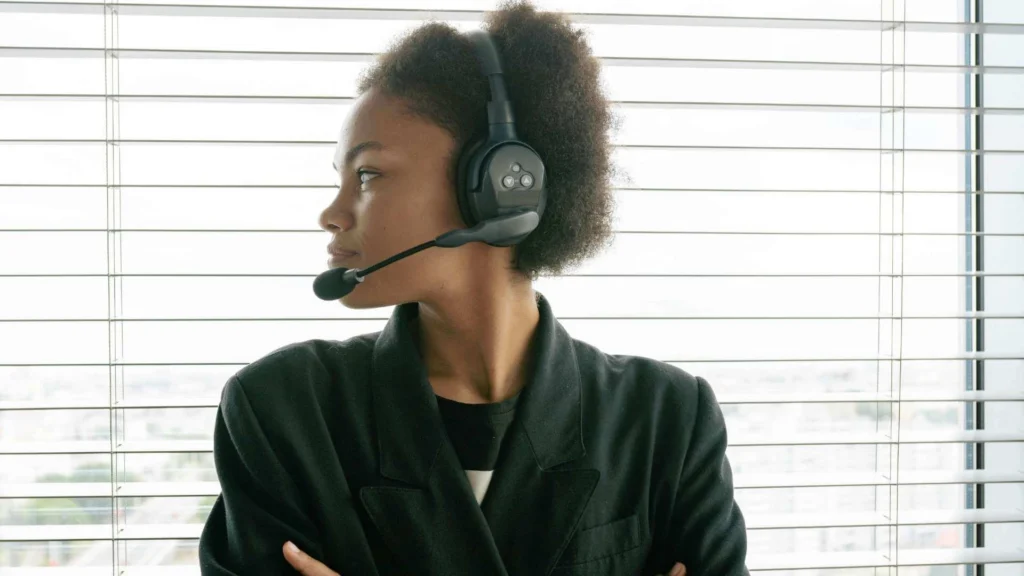 A person looking through a window while on headphones