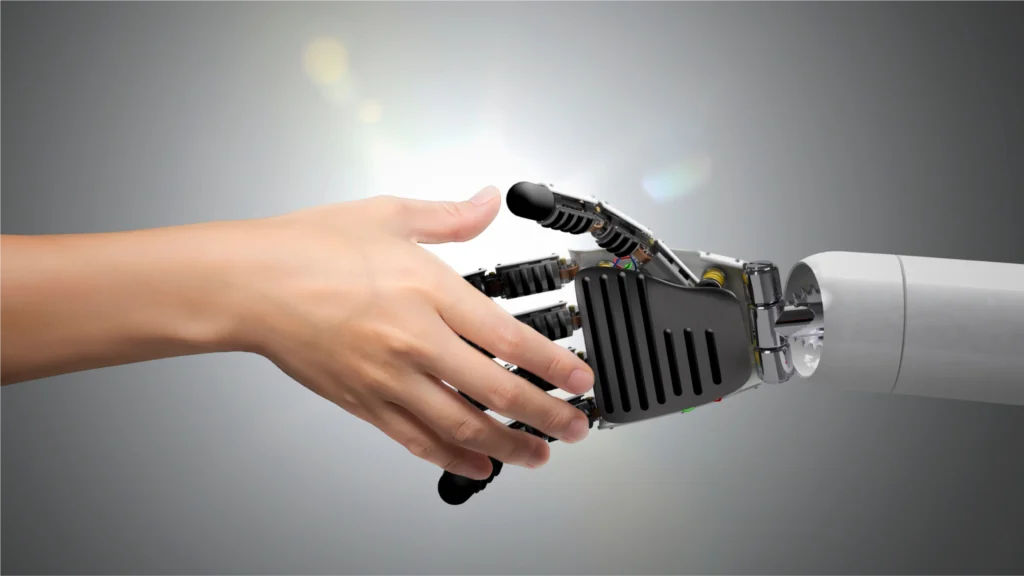A human hand reaching out to connect with a metallic robotic hand, symbolizing collaboration between humans and technology.