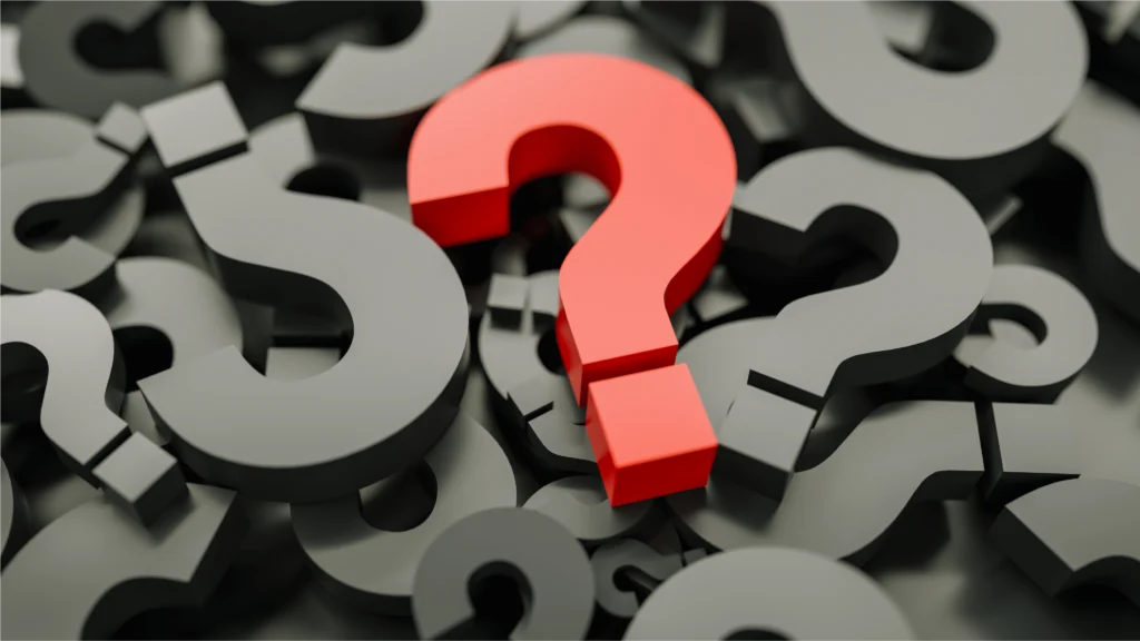 A prominent red question mark stands out among numerous gray question marks.
