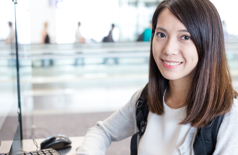 Smiling woman at a desk in a bright office