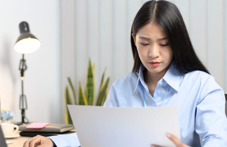 Woman reading a document at her desk