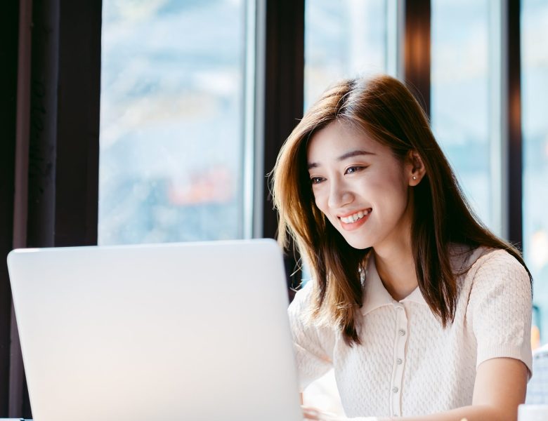 Smiling woman working on a laptop