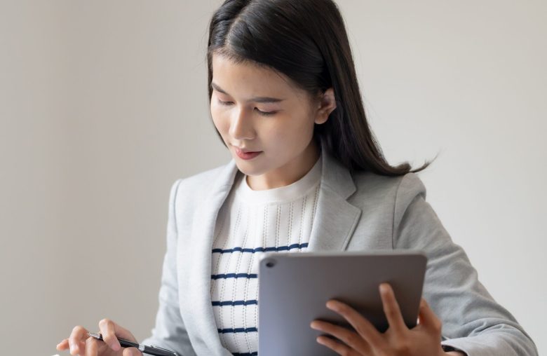 Woman in a blazer using a tablet