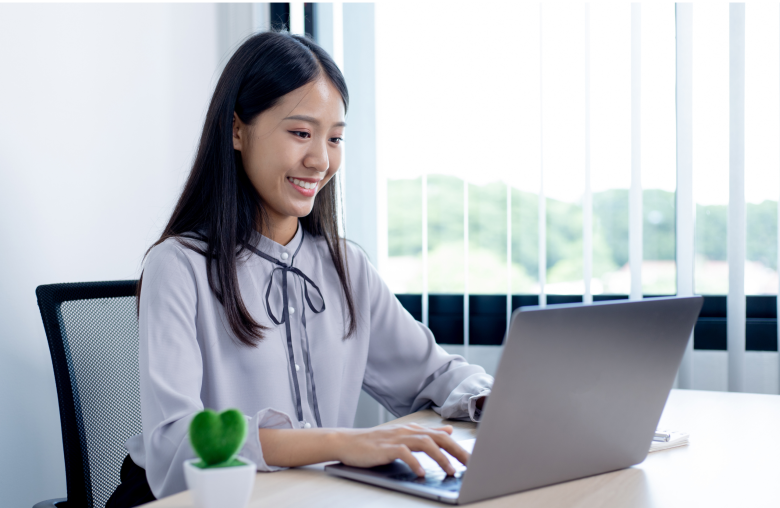 Woman typing on a laptop at a desk