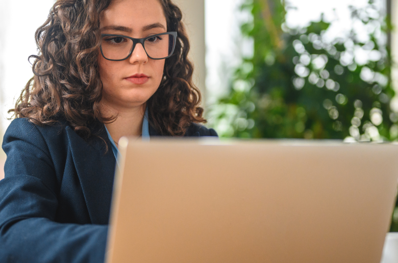 Woman in glasses working on a laptop