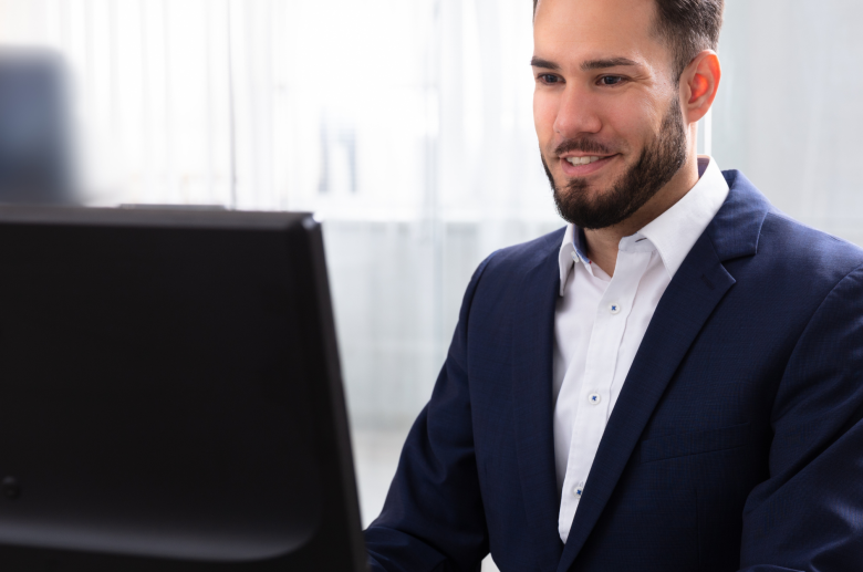 Man in a suit working at a computer