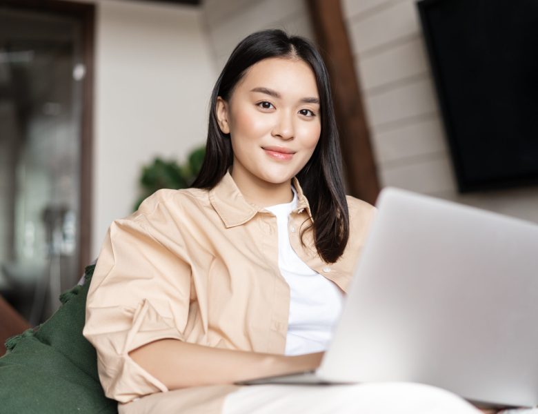 Smiling woman sitting with a laptop