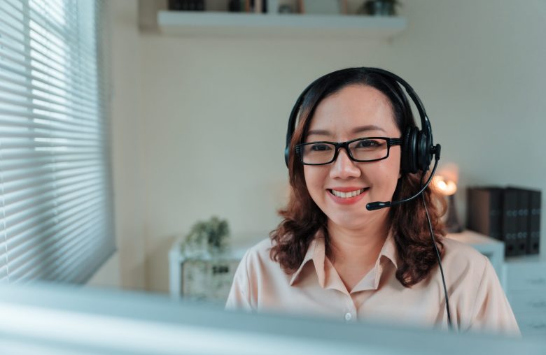 Smiling woman wearing a headset and glasses
