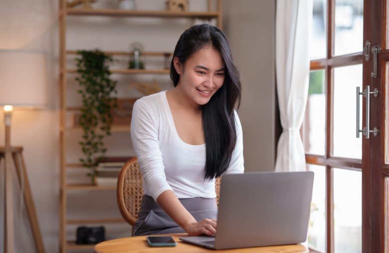 Smiling woman working on a laptop
