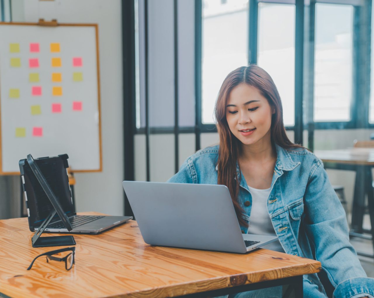 Woman working on a laptop at a desk