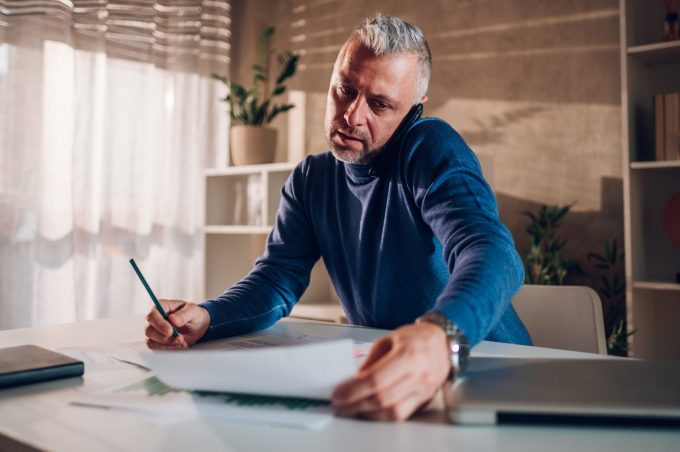 Man writing notes at a desk